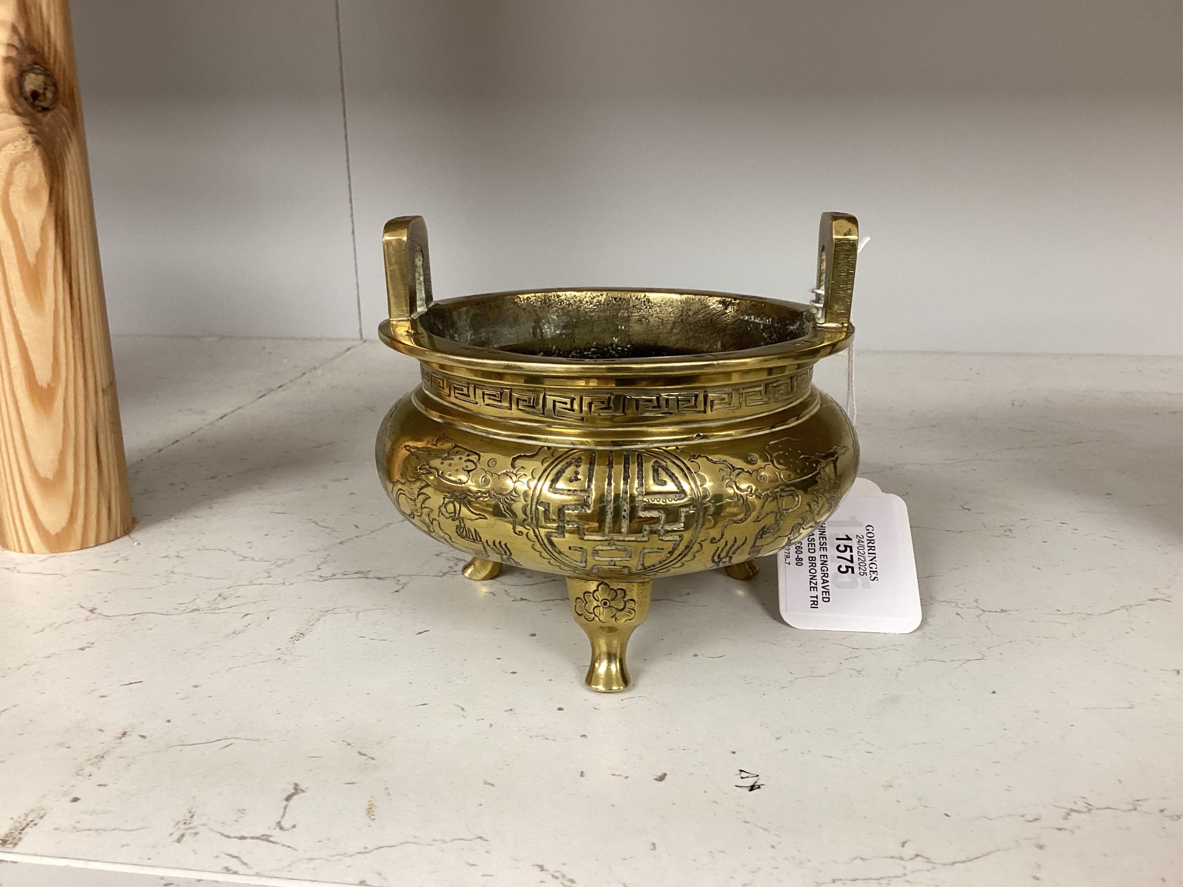 A Chinese engraved and chased bronze tripod censer, Xuande mark, early 20th century, 10.5cm. Condition - good